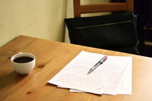 papers and pen on a table at a coffee shop for in person tutoring